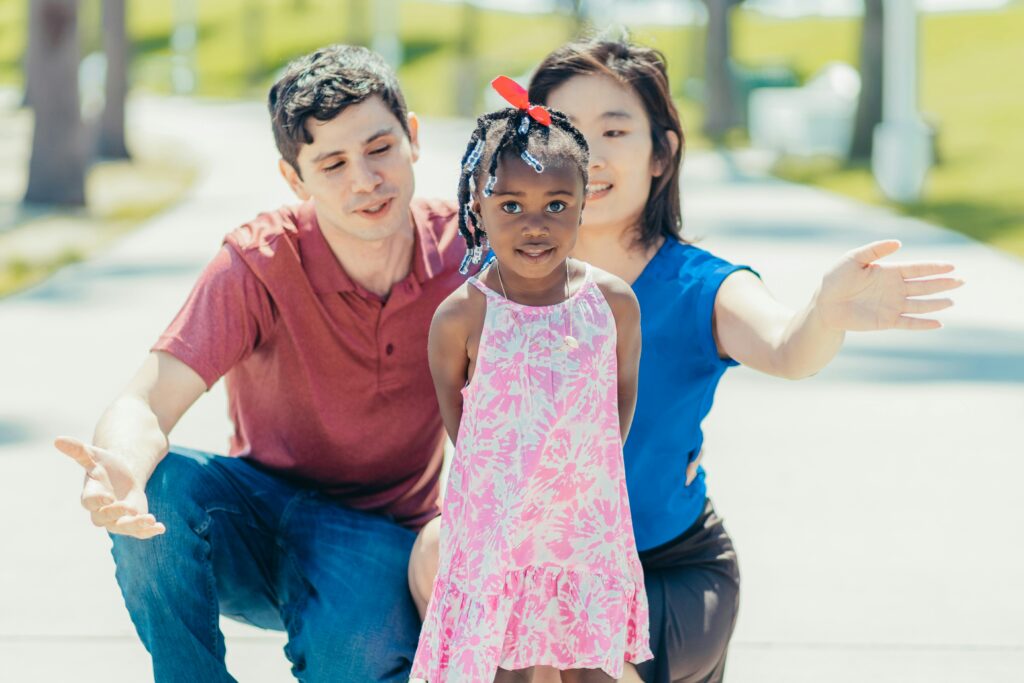 pexels-photo-7978485-7978485 A multiracial family shares joyful bonding moments outdoors on a sunny day.